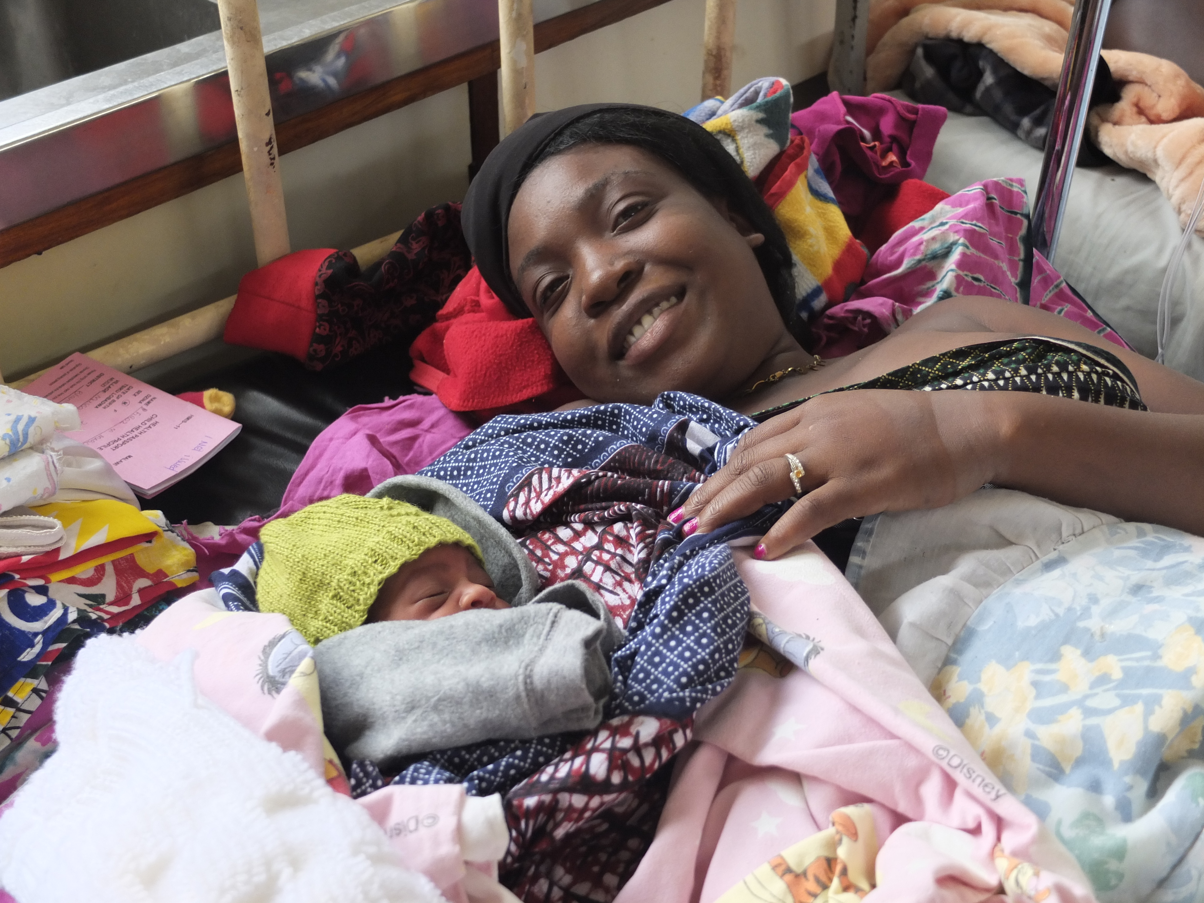 Mother rests next to her baby after birth